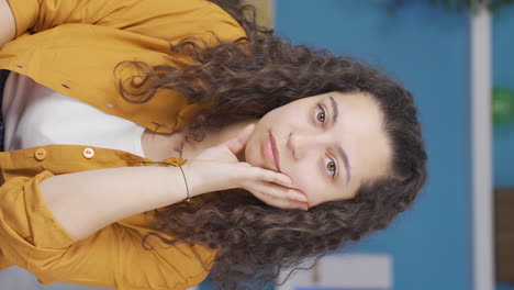 Vertical-video-of-Young-woman-looking-depressed-at-camera.